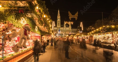 VIENNA, AUSTRIA – DECEMBER 2015 : Moving timelapse of christmas market on slider at night with Rathaus / City Hall and christmas lights in view