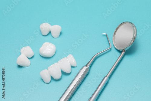 Close up dental tools and Tooth implant on a Turquoise background
