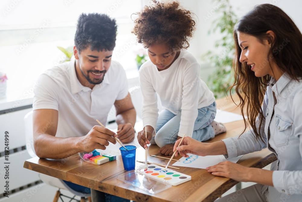 Mother and father drawing together with their child Mother and father drawing together with their child