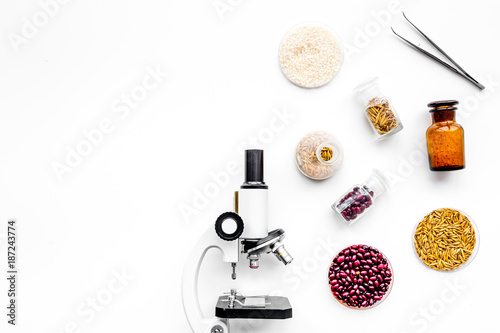 Food safety. Wheat, rice and red beans near microscope on white background top view copyspace