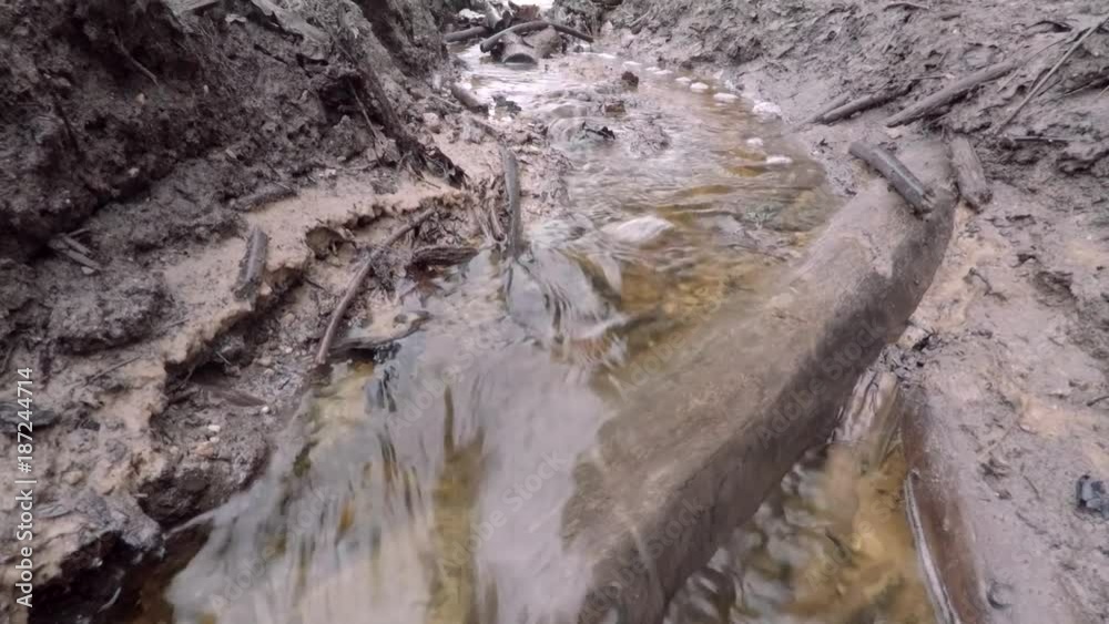 Spring impassable destroyed road. Tall water from the snow fills the ...