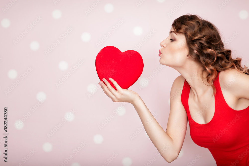 woman with red hearts on pink background.