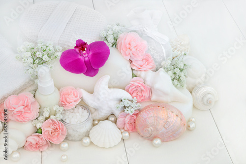 Beauty treatment cleansing and ex foliation products with orchids and carnation flowers, ex foliating salt, body lotion, seashell soaps, sponges, wash cloths, decorative shells and pearls.