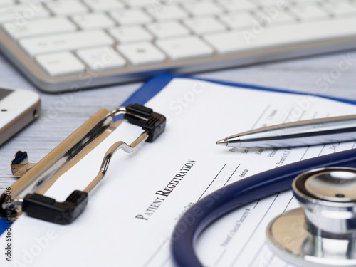 Stethoscope lying on patient registration form