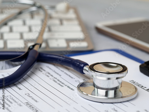 Stethoscope lying on patient medical history