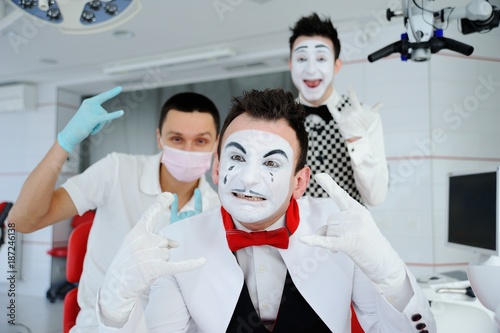 Male mime patient and doctor on background of clinic or operating room. Medical Day