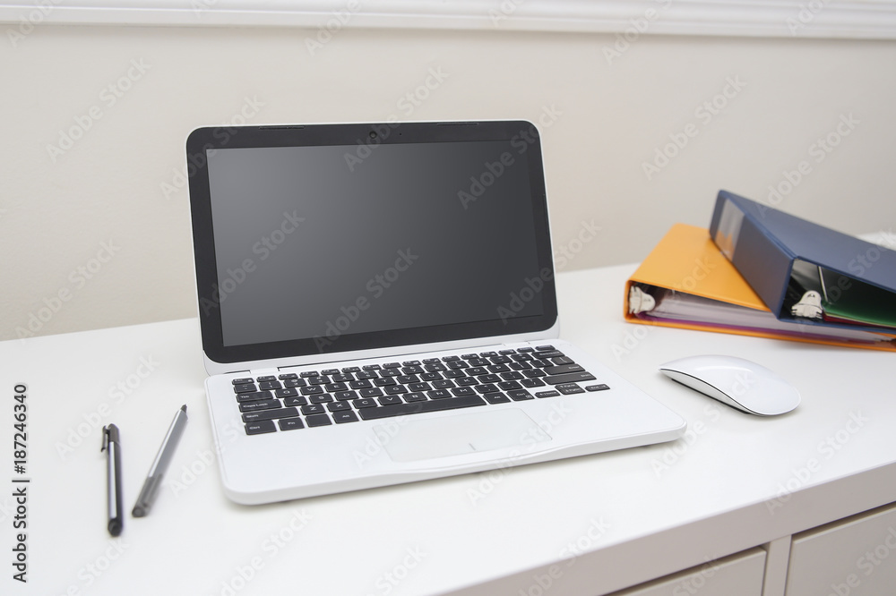 Student desk with laptop and binders Student desk with laptop and binders