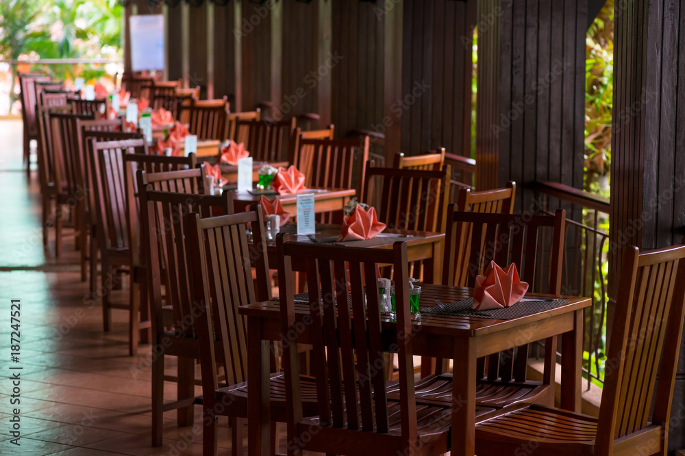 empty tables with pink napkins on the veranda in the early morning