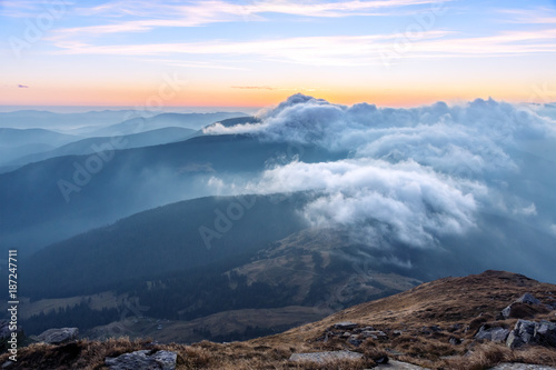 Mountains View many stacked foggy ranges and purple Clouds