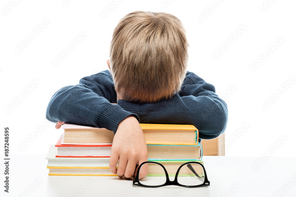a tired little schoolboy fell asleep on books during a lesson a tired little schoolboy fell asleep on books during a lesson