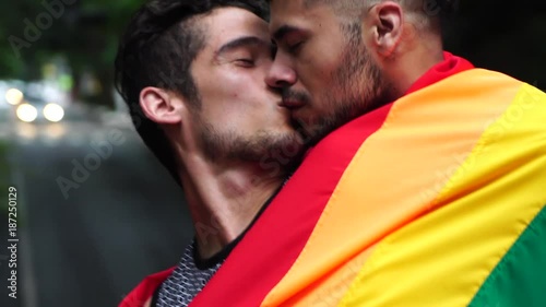 Homosexual Couple Celebrating with Rainbow Flag photo