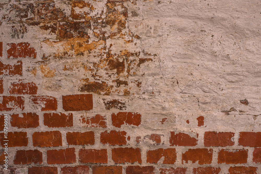Brick wall with the remains of white paint - beautiful vintage grunge background