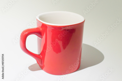 Empty red and white coffee cup on a white background