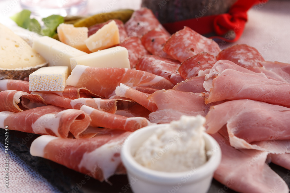 Plate of speck and typical italian salami with cheese and pickles, Cortina D'Ampezzo, Italy