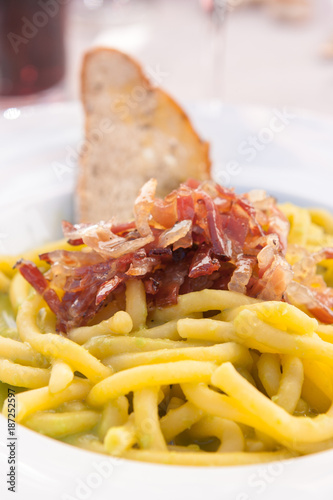 Plate of bigoli (italian pasta) with speck and peas cream, Cortina D'Ampezzo, Italy