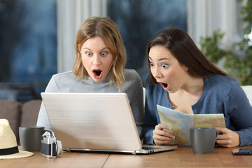 Two tourists finding offer on line in an apartment