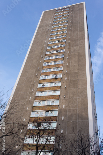 Tall council flat tower block of apartments in brutalist style viewed from below