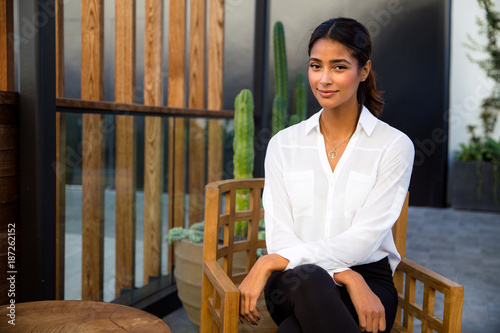 Εκτύπωση καμβά Gorgeous mixed race woman sitting relaxed with peace of mind on home and garden