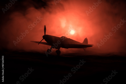 British jet-propelled model plane in possession. Dark orange fire background. War scene.