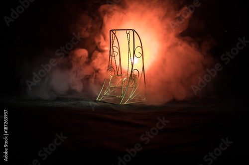 Silhouette of fire breathing dragon with big wings on a dark orange background. Horror image photo