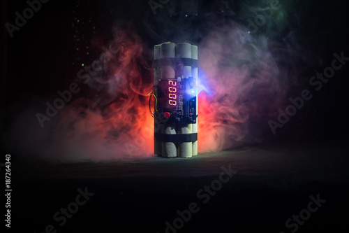 Image of a time bomb against dark background. Timer counting down to detonation illuminated in a shaft light shining through the darkness photo