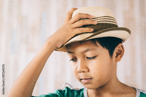 Young asian boy wearing hat happily and smiling.clothing travel concept