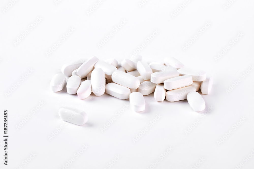 White medical pills on white background. Medical tablets on white background. Medicine and health care concept. White medical pills on white background. Medical tablets on white background. Medicine and health care concept.