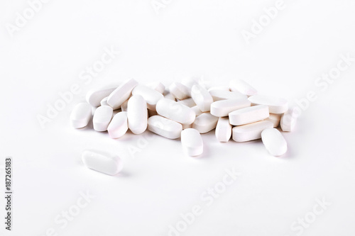 White medical pills on white background. Medical tablets on white background. Medicine and health care concept.