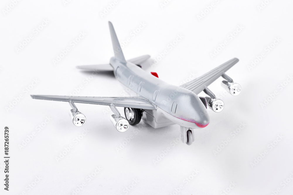 Grey toy air plane on white background. Plastic toy jet plane isolated on white background. Photo of toy air transport. Grey toy air plane on white background. Plastic toy jet plane isolated on white background. Photo of toy air transport.
