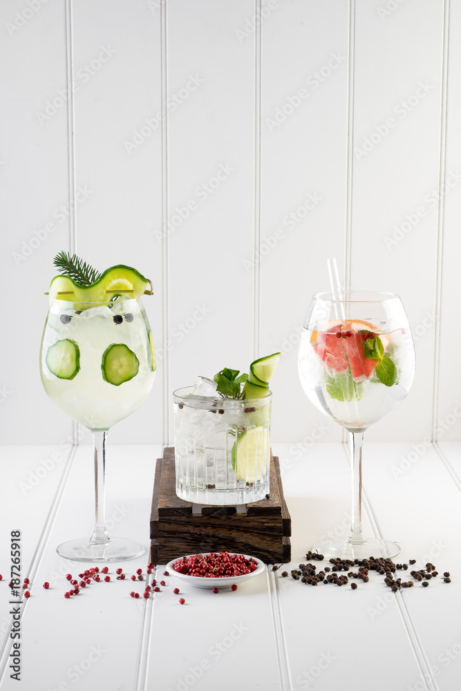 gin and tonic alcohol drink cocktail glass ice fruit garnish plain black white background
