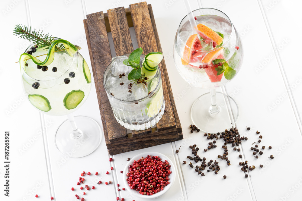 gin and tonic alcohol drink cocktail glass ice fruit garnish plain black white background