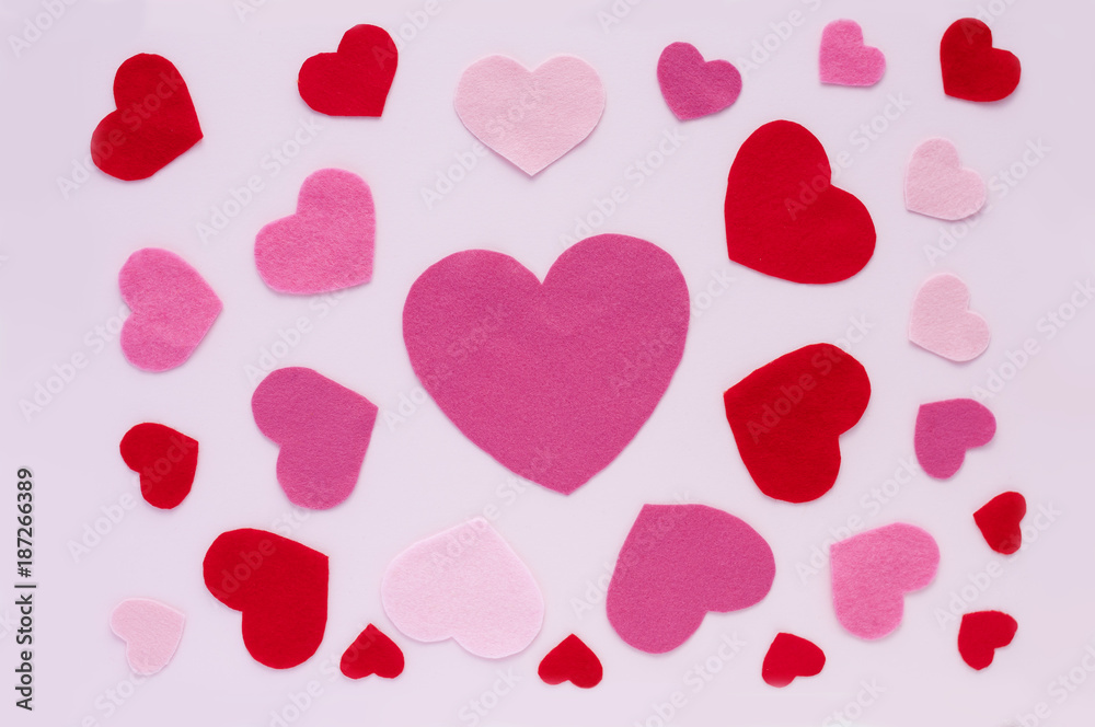 Horizontal Card Valentine's Day. On a light pink background, red and pink hearts of different sizes with copy space.