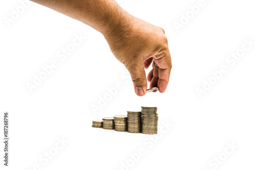 coin stacks with hand on white background