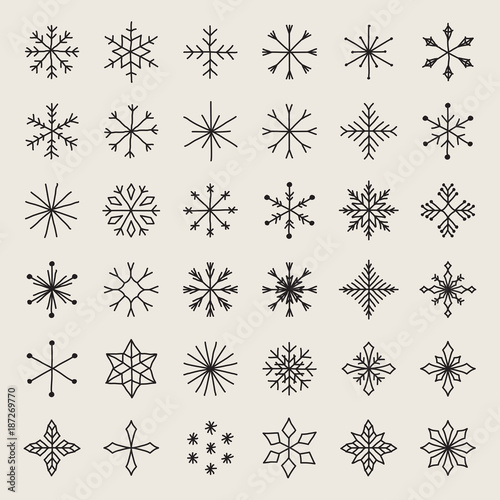 Set of hand drawn snowflakes. Delicate snow icon silhouettes. Vector illustration with editable strokes. Isolated on white background. Winter design elements for christmas and seasonal greetings.