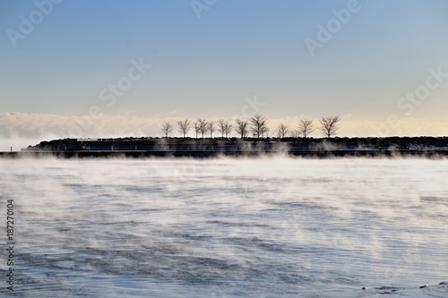 Vapor rises from still flowing water as it turns to Ice on Lake Michigan waters in Chicago's 31st Street Harbor. Winds and bitter cold conspired to create the conditions.