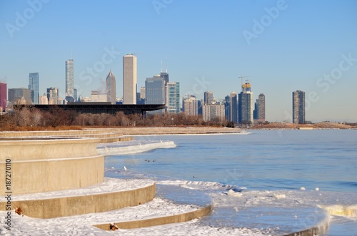 Winds and bitter cold with wind chill factors exceeding minus 20 degrees created vapor both above the forming ice in Lake Michgan in front of the Chicago skyline.
