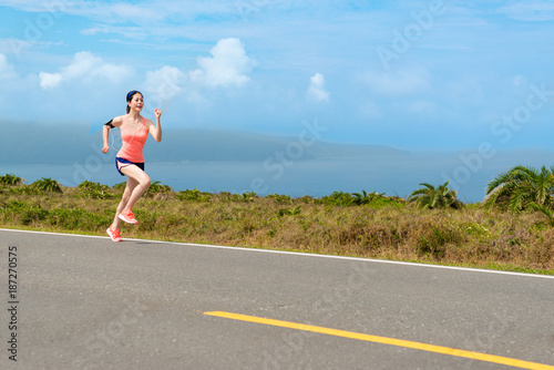 marathon player woman running on asphalt road