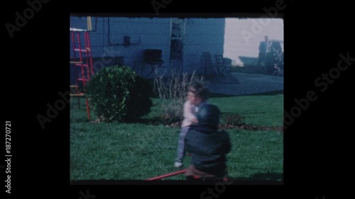 1964 2 little kids ride on backyard whirly gig ride photo
