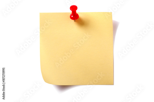 One single yellow square sticky post it note with pushpin curled corner and shadow isolated on white background photo