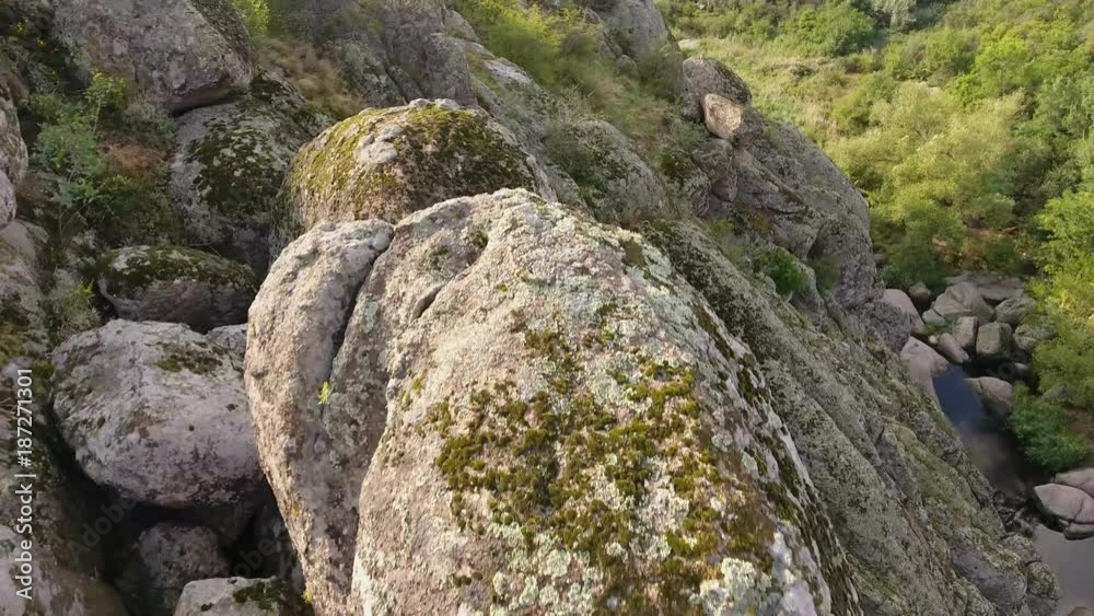 An enigmatic view of some mountains covered with huge cubic and half round stones and patches of greenery on the Black Sea coast in Ukraine. An enigmatic view of some mountains covered with huge cubic and half round stones and patches of greenery on the Black Sea coast in Ukraine.