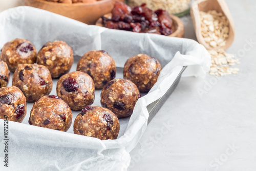 Healthy homemade energy balls with cranberries, nuts, dates and rolled oats, horizontal, copy space