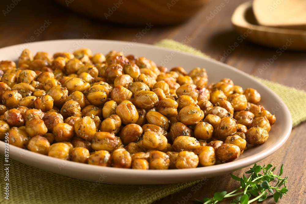 Chickpeas roasted with thyme, oregano, salt and pepper, photographed with natural light (Selective Focus, Focus in the middle of the chickpeas) Chickpeas roasted with thyme, oregano, salt and pepper, photographed with natural light (Selective Focus, Focus in the middle of the chickpeas)