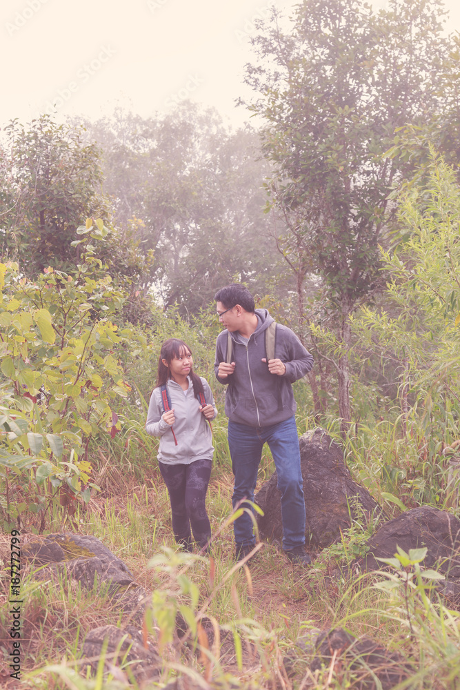 Asia Father and daughter backpack behind go hiking or climbing in Nature Mountain. retro tone. Asia Father and daughter backpack behind go hiking or climbing in Nature Mountain. retro tone.
