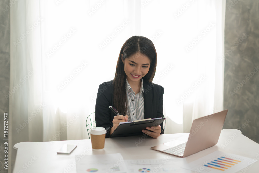 Beautiful asian young businesswoman. Happy working in her workstation Beautiful asian young businesswoman. Happy working in her workstation