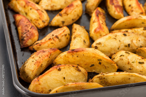 Foto Baked potatoes on baking sheet