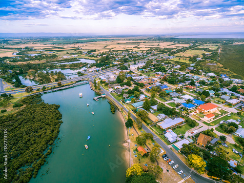Aerial view of rural homes and river near ocean in Australia photo