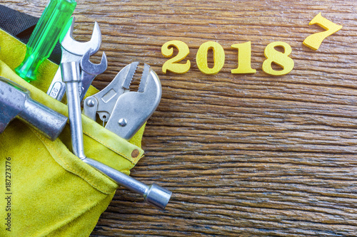 Tool belt with tools isolated on wood background.selective focus photo