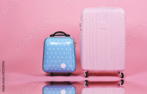 Принти на полотні Set of luggage suitcase, Traveler pink suitcase and blue cabin size luggage on pink background, Journey and travel concept