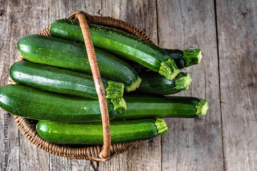 Fresh zucchini, green vegetables, farm fresh organic produce from farmer market, overhead in the basket