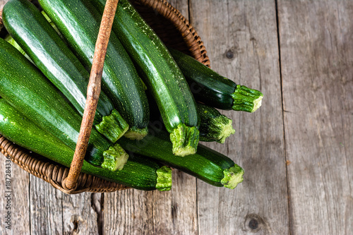 Fresh zucchini, green vegetables on local farmer market, freshly harvested courgette, summer squash